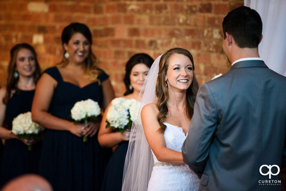 Bride smiling during the wedding ceremony.