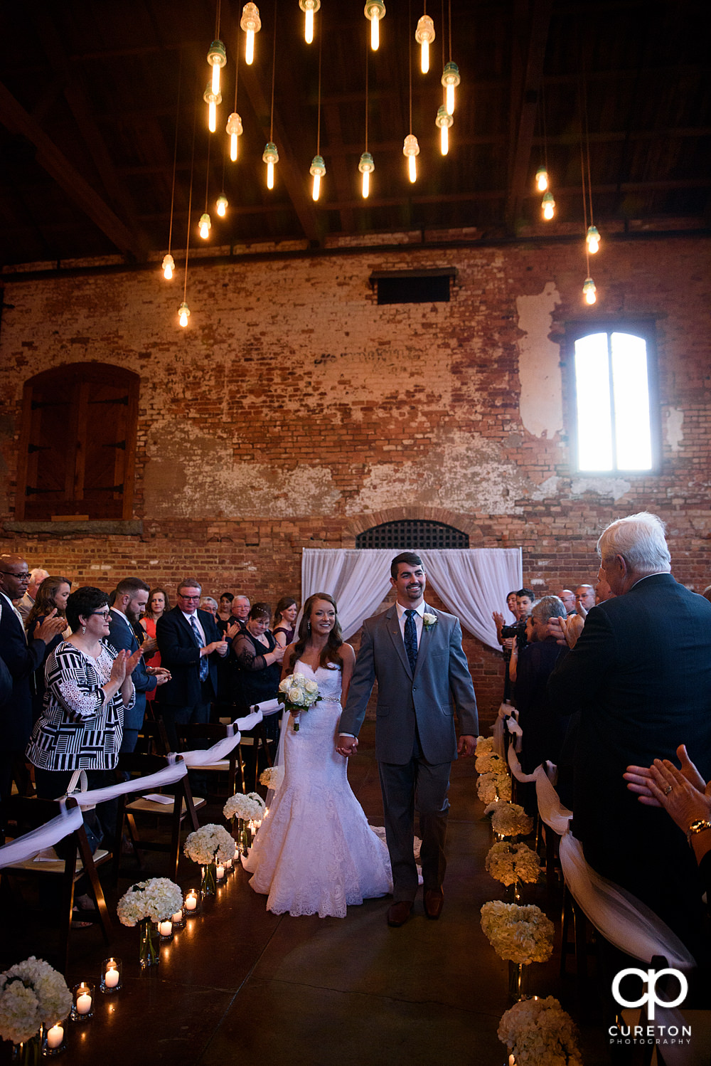 Bride and groom walking back down the aisle.