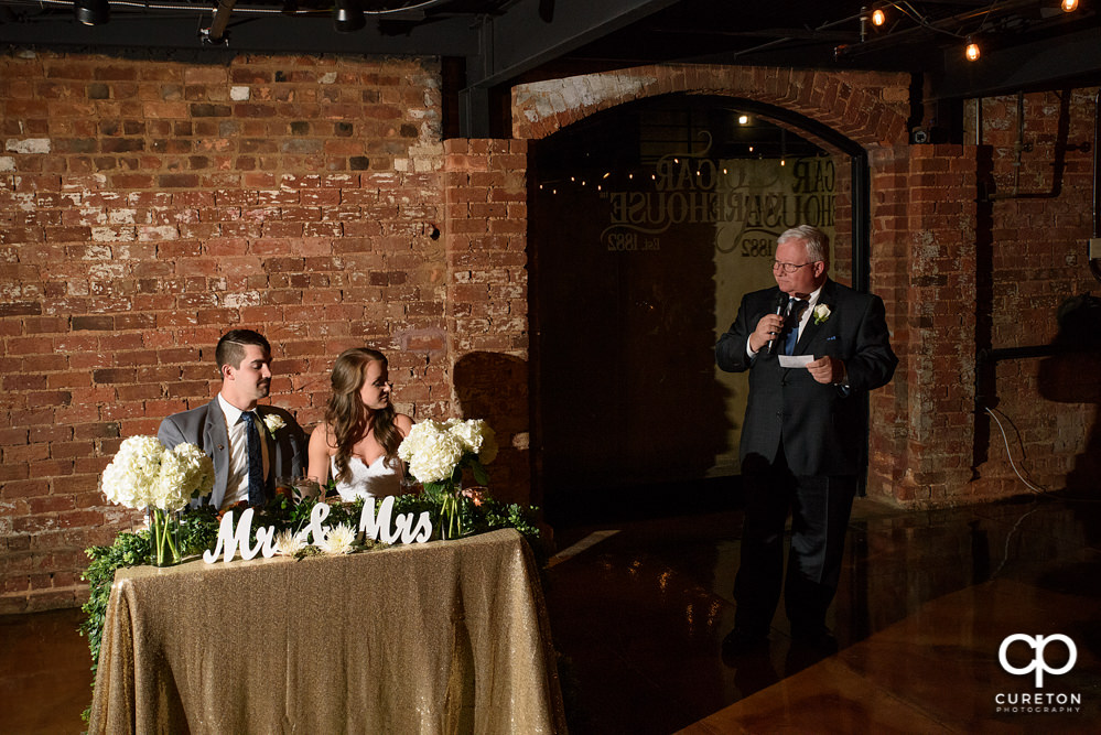 Bride's father giving a toast.