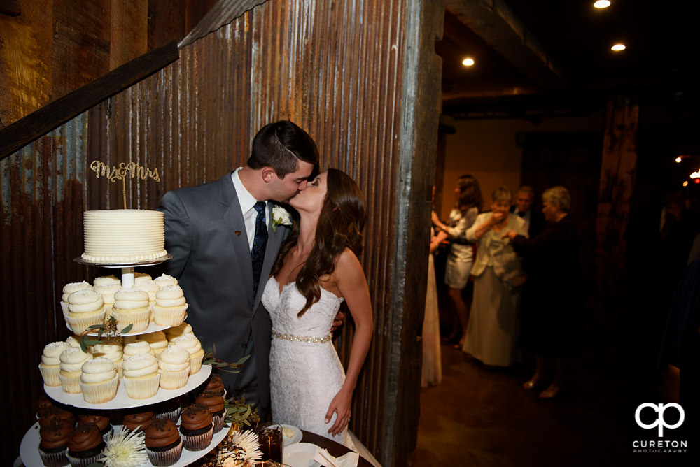 Bride and groom cutting the cake.