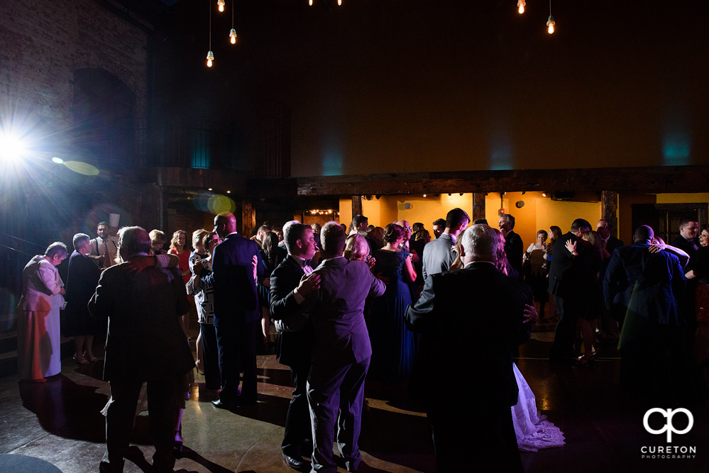 Guests dancing at the wedding reception to the sounds of Uptown Entertainment.