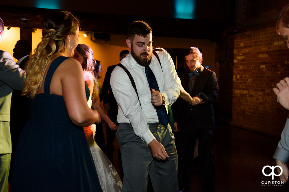 Guests dancing at the wedding reception to the sounds of Uptown Entertainment.
