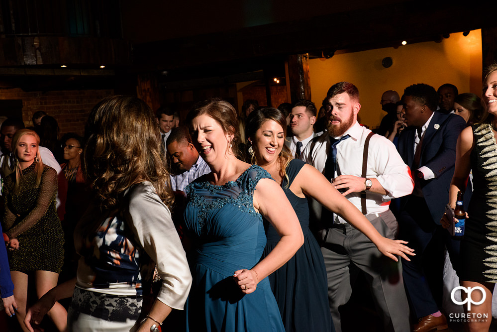 Guests dancing at the wedding reception to the sounds of Uptown Entertainment.