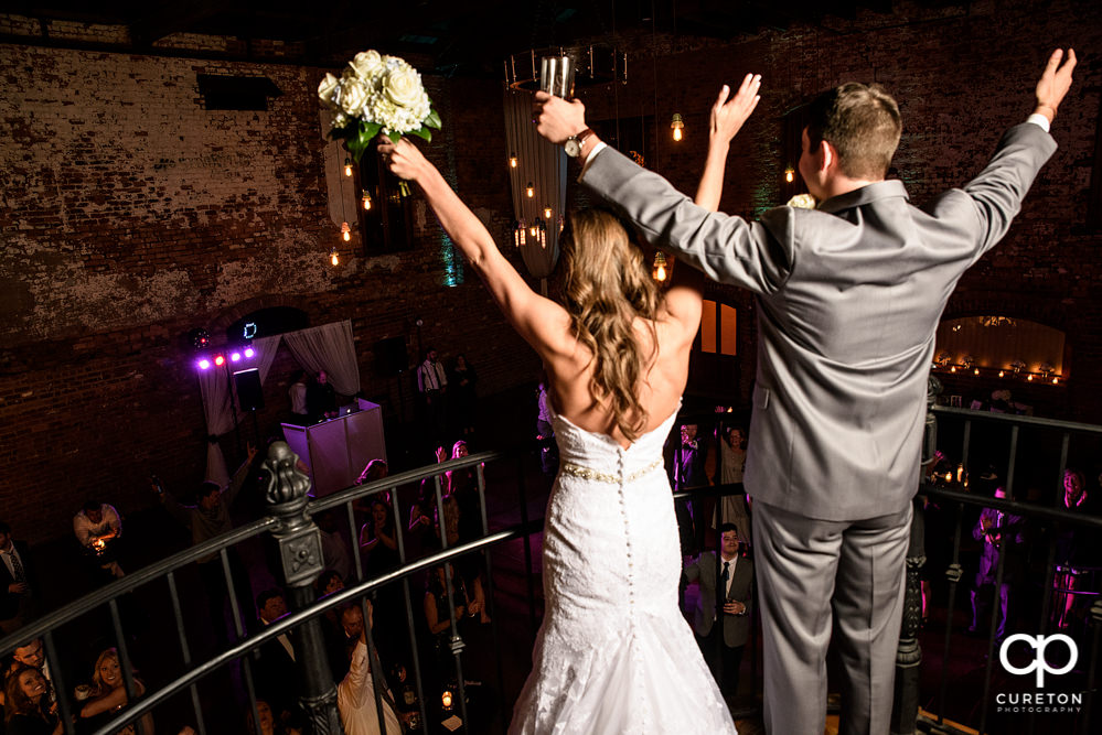 Bride and groom overlooking the reception.