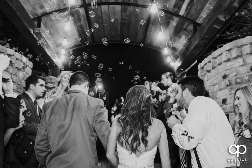 Bride and groom bubble leave at The Old Cigar Warehouse wedding.
