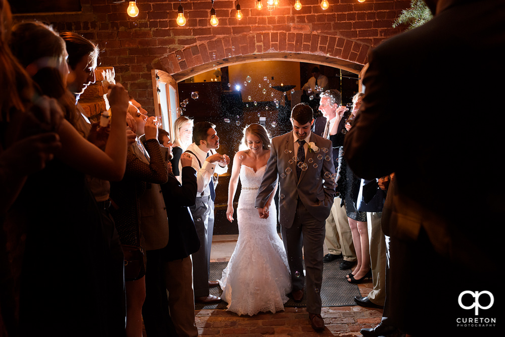 Bride and groom bubble leave at The Old Cigar Warehouse wedding.