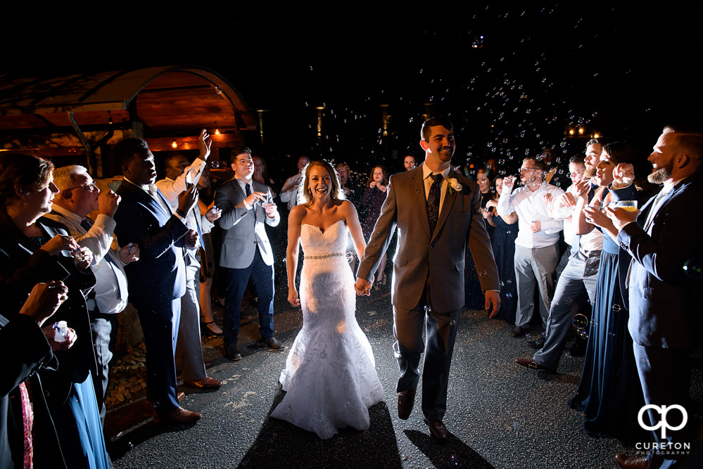 Bride and groom bubble leave at The Old Cigar Warehouse wedding.