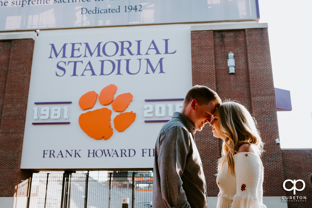 Future bride and groom standing outside Memorial Stadium (Death Valley) during their engagement session in Clemson,SC.