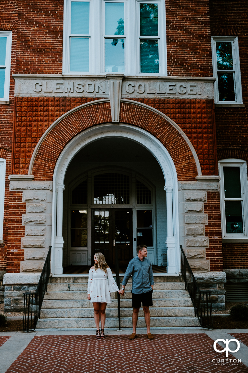 Couple in front of Tillman Hall during an engagement session on the Clemson University campus.