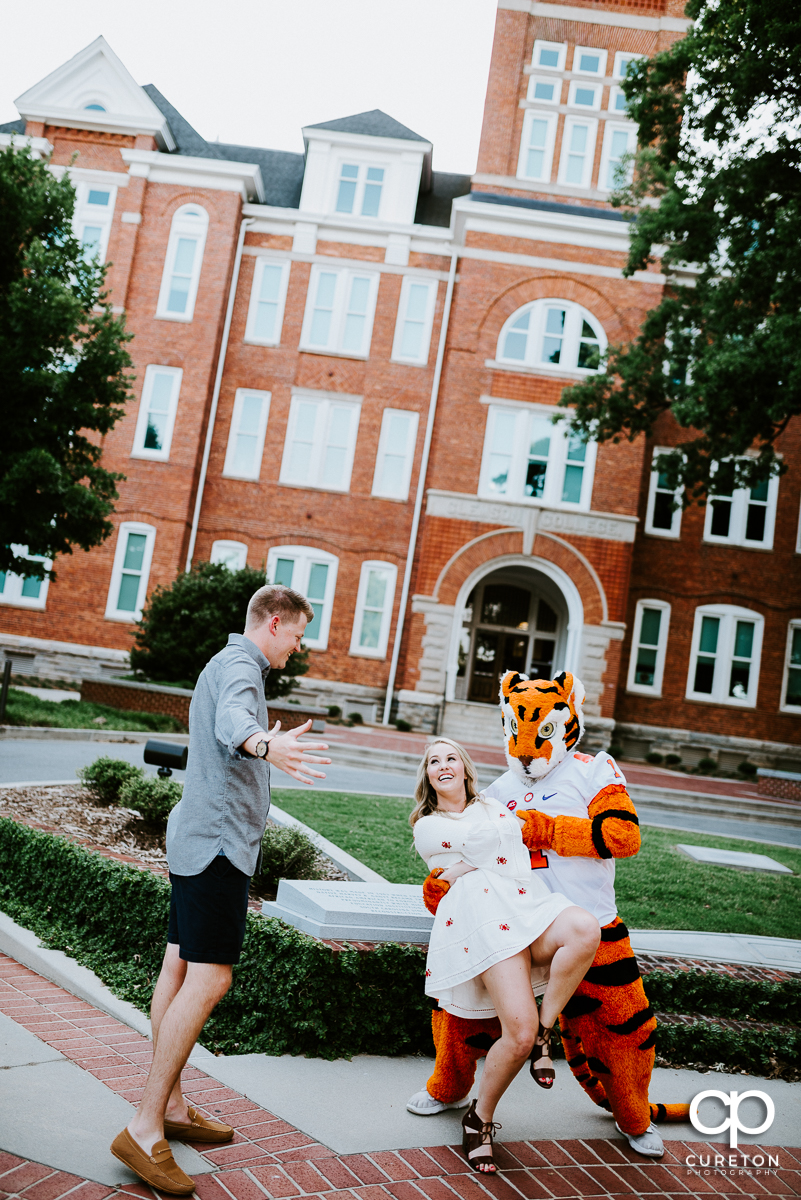 Clemson Tiger mascot dipping a future bride while her fiancee looks on.