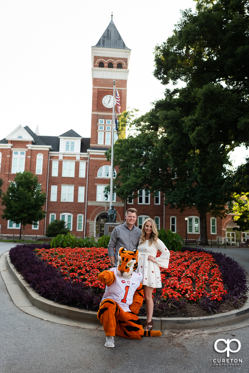 Future bride and groom outside Tillman Hall during their engagement session with the Clemson Tiger mascot.