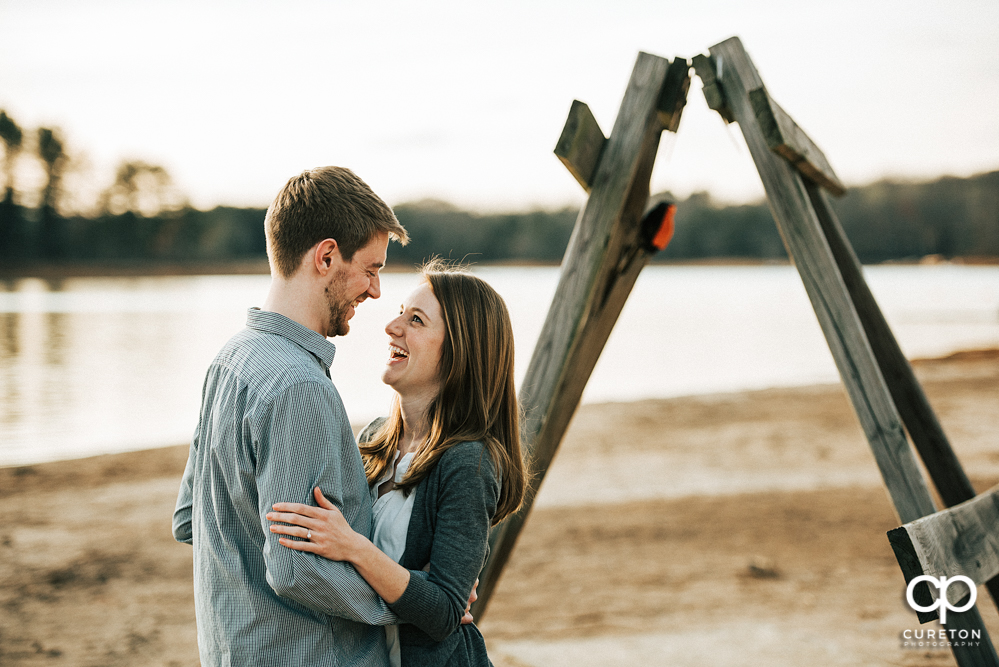 Man and woman laughing during their engagement session.