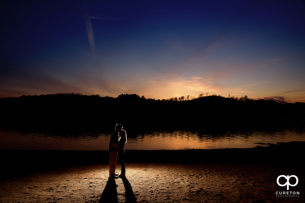 Silhouette of a couple during an engagement session at the lake in Clemson.
