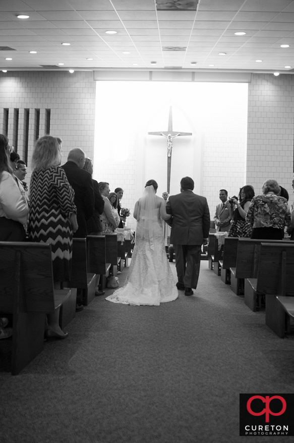 Bride and father walking down the aisle of St. Andrews Church in Clemson,SC.