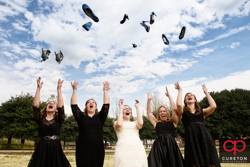 Creative bridesmaids photo of them all throwing shoes in the air.