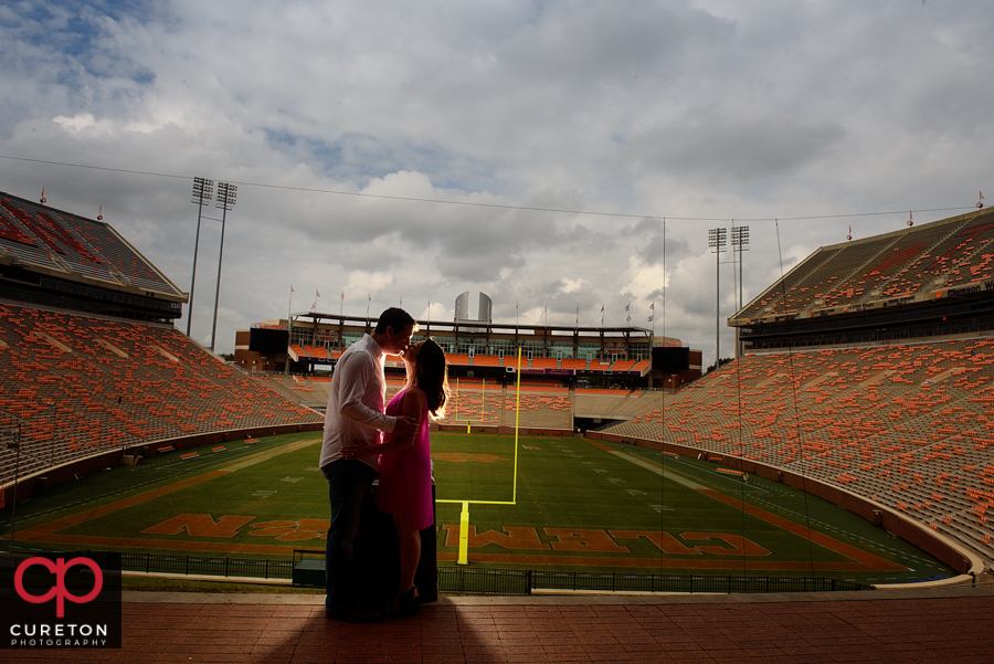 Bride and groom kissing over Howard's rock in Death Valley during a Clemson engagement session.