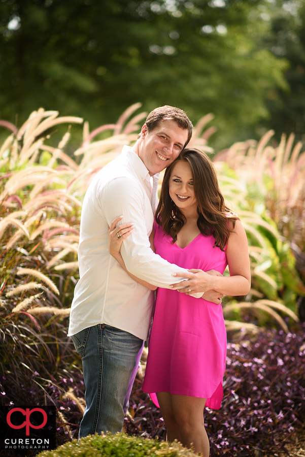 Engaged couple in the flowers near Tillman Hall on the Clemson UNiversity canpus.