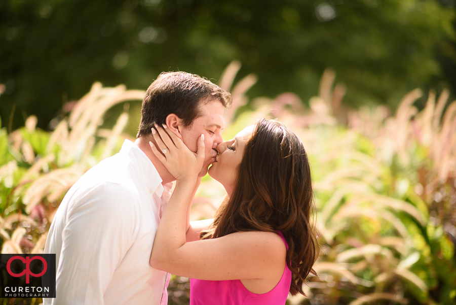 Engaged couple in the flowers near Tillman Hall on the Clemson UNiversity canpus.