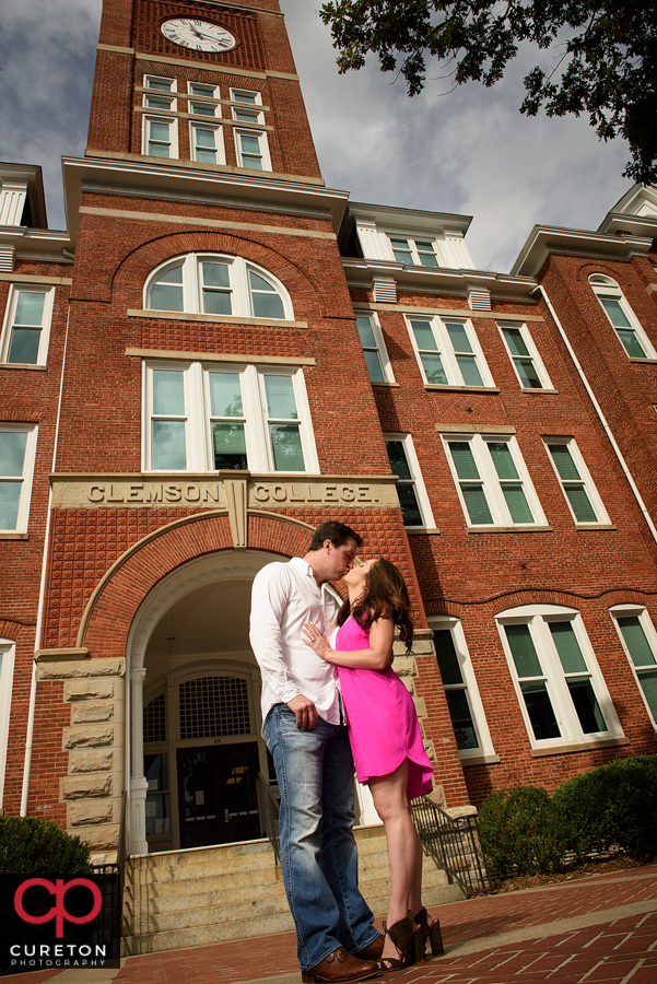 Couple kissing in front of Tillman Hall during a Clemson University Engagement Session.