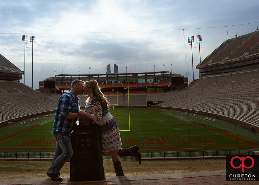 Couple kissing at Howard's rock during a Clemson stadium engagement session.