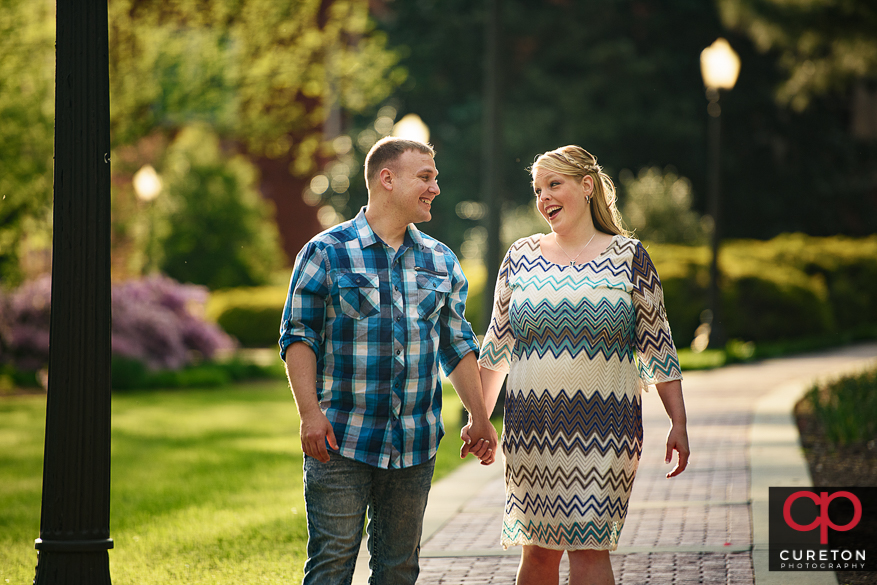 Engaged couple in amazing sunlight during a Clemson engagement session.
