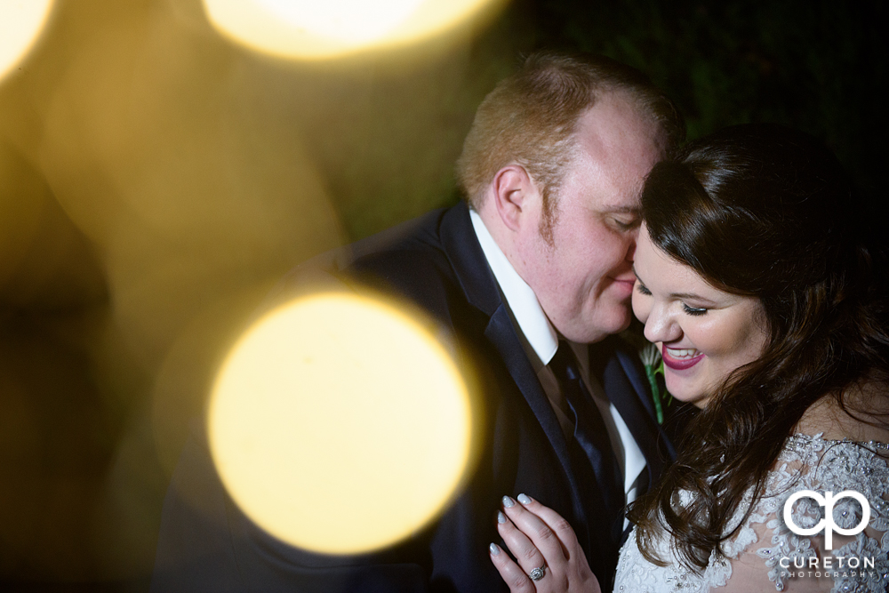 Bride and groom laughing.