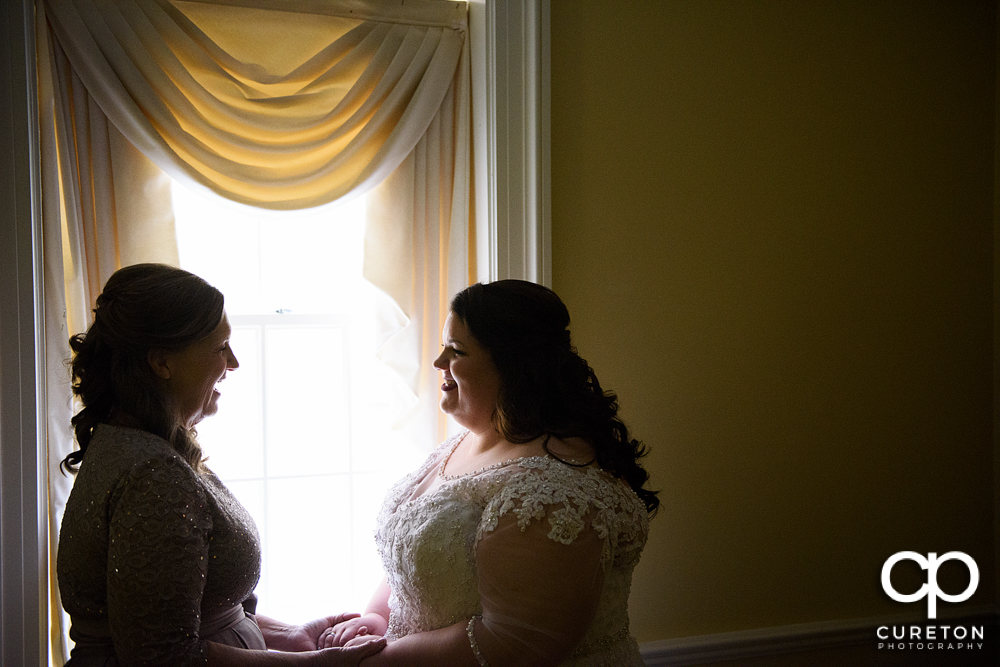 Bride and her mother having a moment before the wedding ceremony.