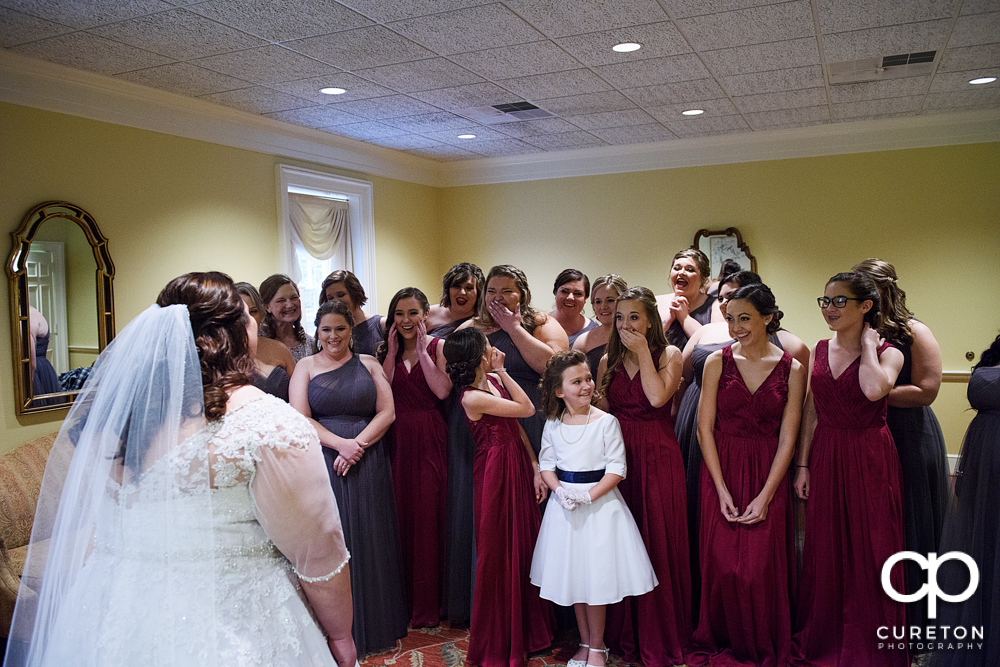 Bridesmaids see the bride for the first time.