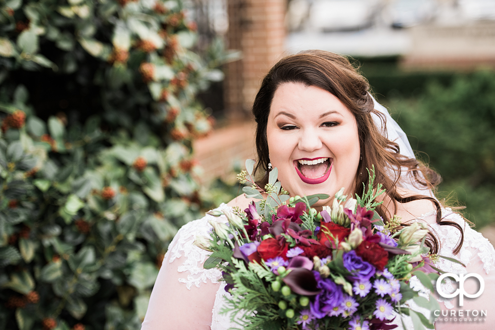 Bride smiling with her flowers.