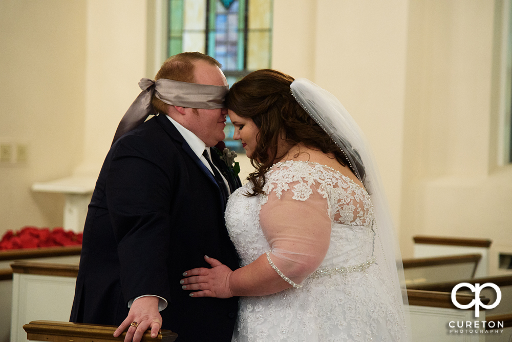 The bride and groom during their first touch before the ceremony.