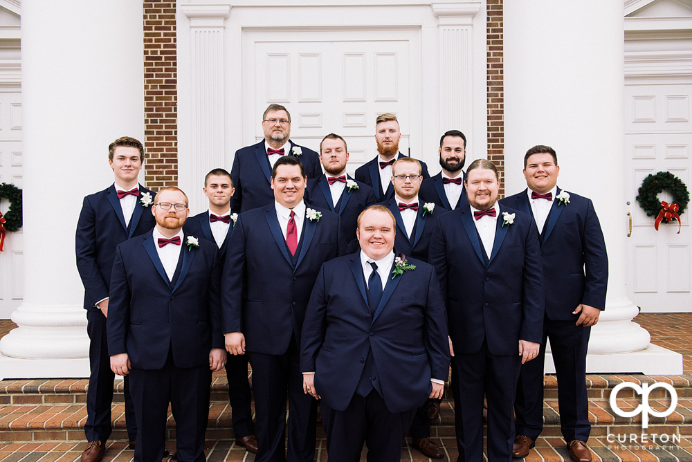 Groom and groomsmen on the steps of the church.