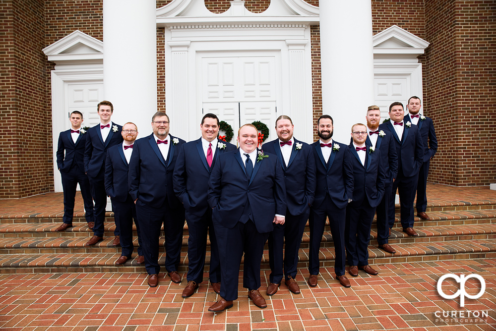 Groom and groomsmen on the steps of the church.