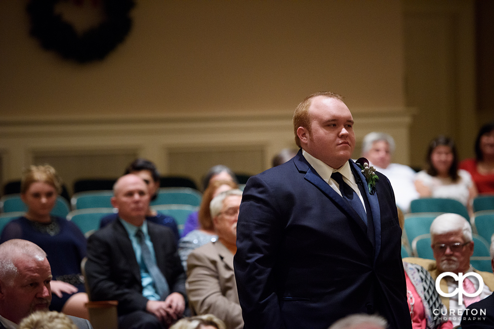 Groom walking down the aisle.