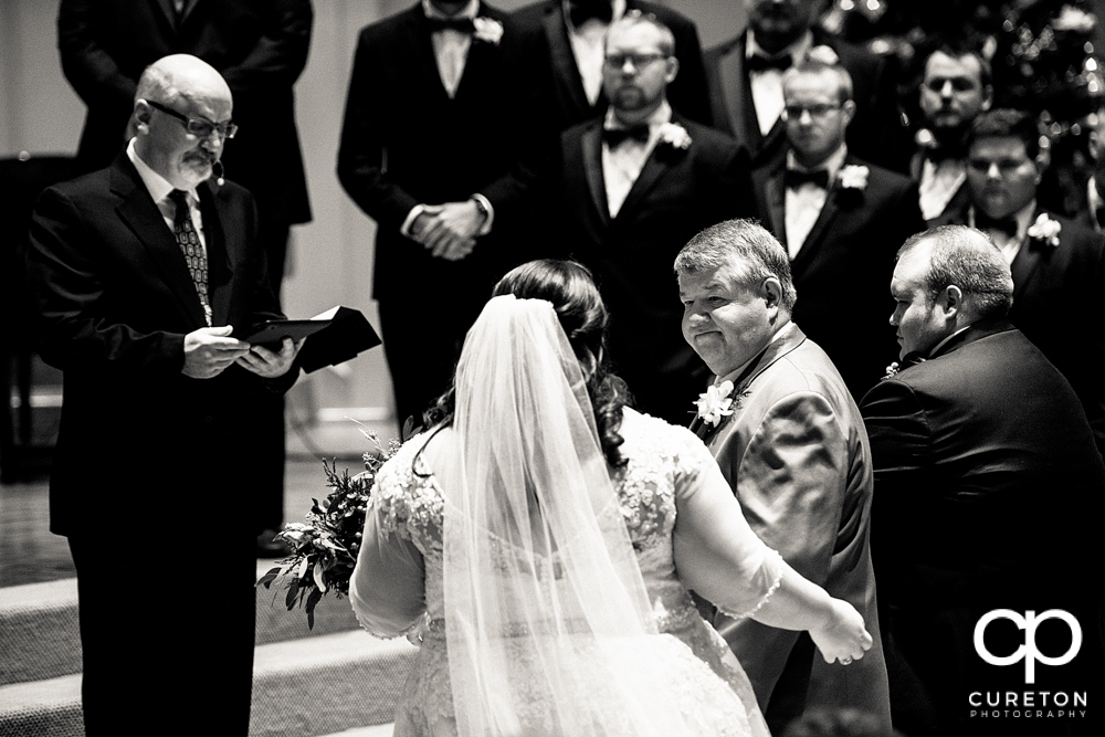 Father gives away his daughter during the ceremony.