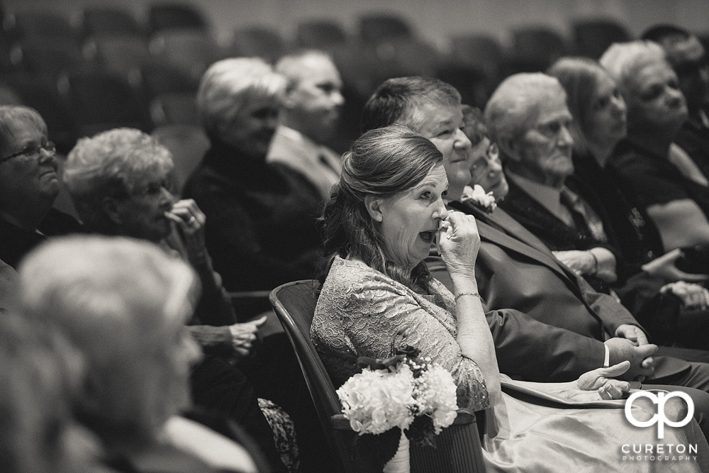 Bride's mother crying during the ceremony.