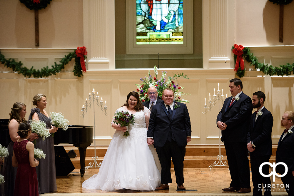 Bride and groom being presented to the church.