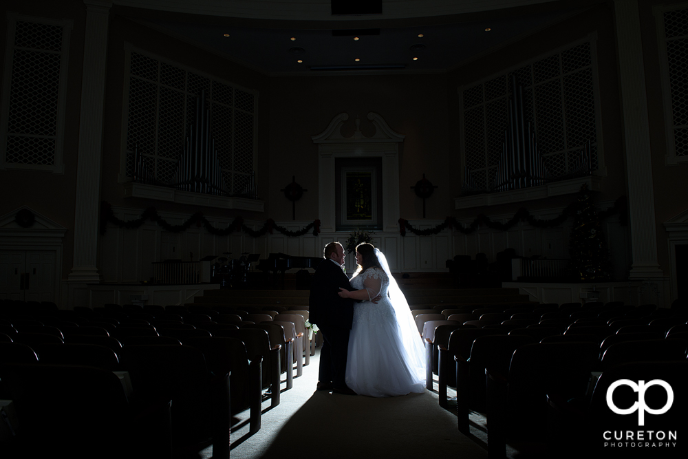 Bride and groom backlit in the church after the Spartanburg wedding,