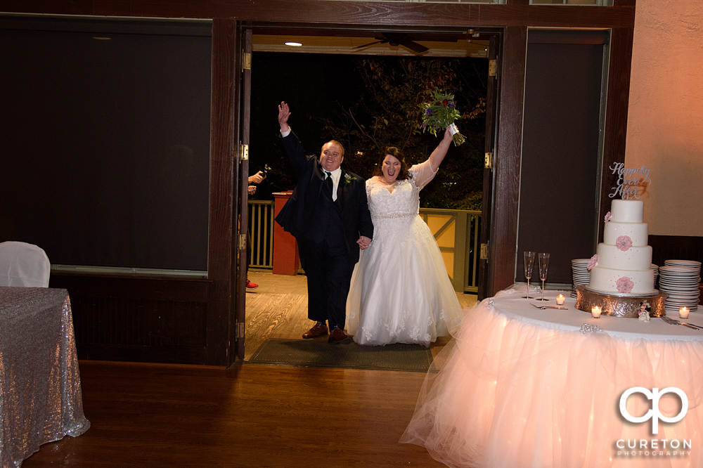 The bride and groom entering the reception.