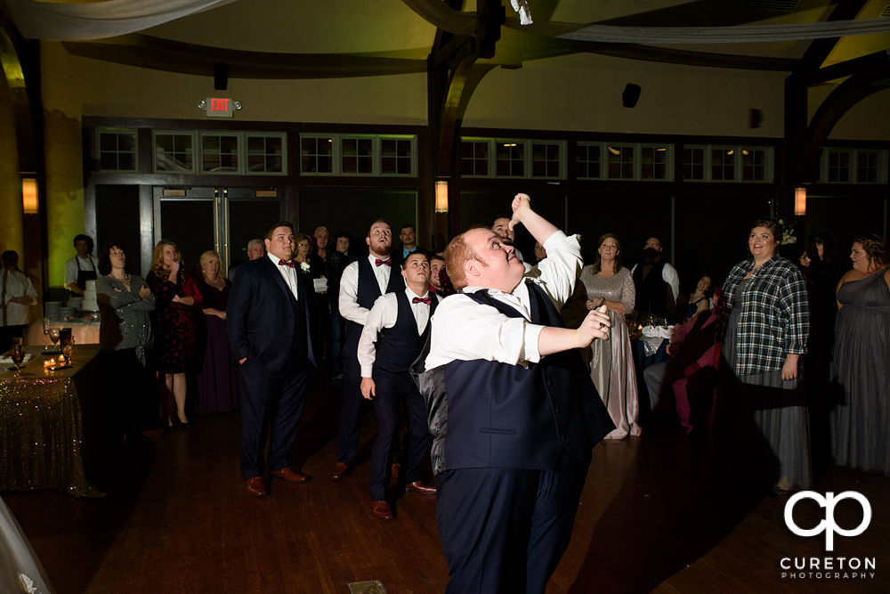 Groom tossing the garter.