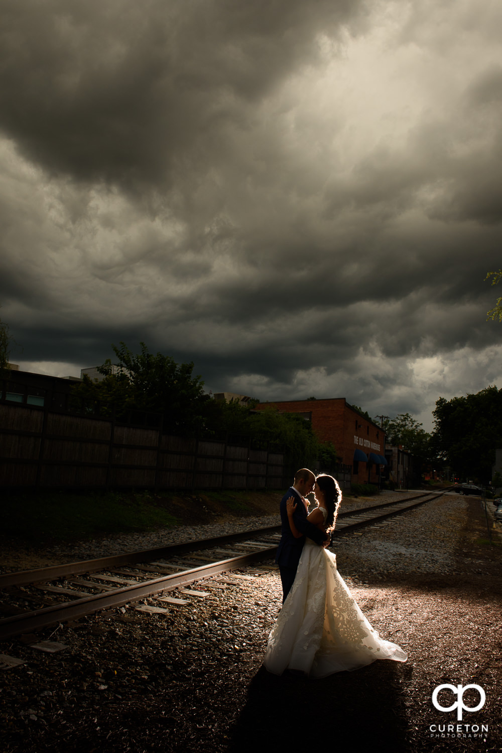 Bride and groom at sunset outside their wedding reception at The Old Cigar Warehouse in downtown Greenville.