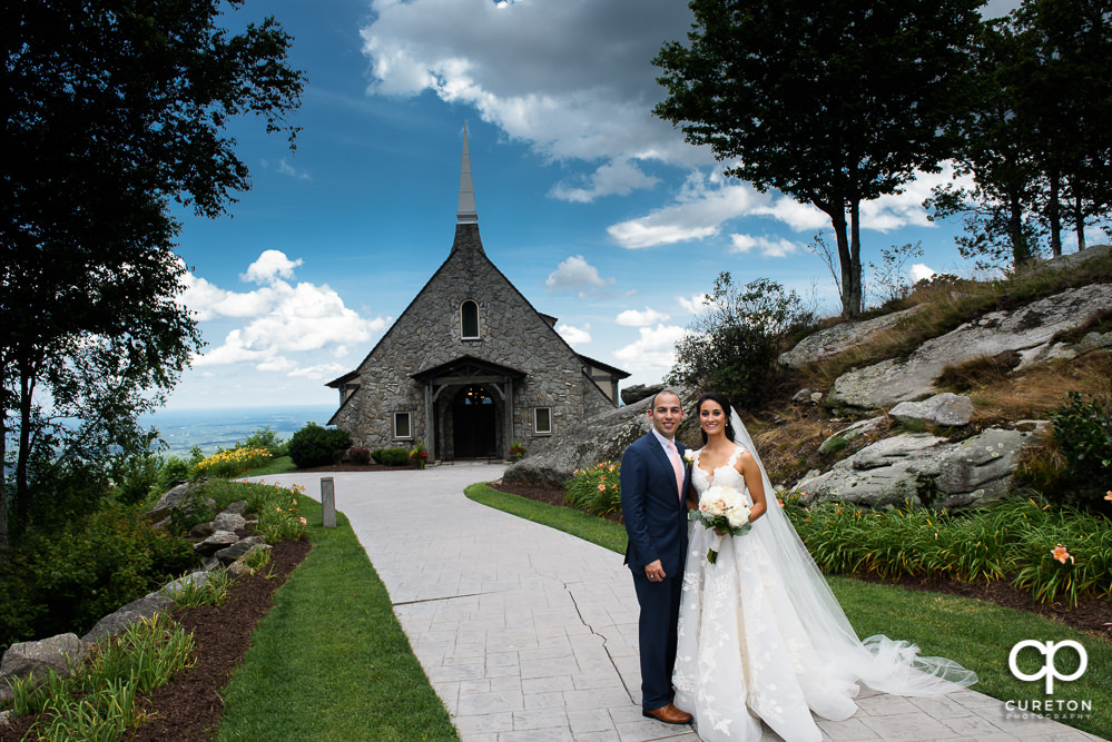 Bride and Groom in front of Glassy Chapel.