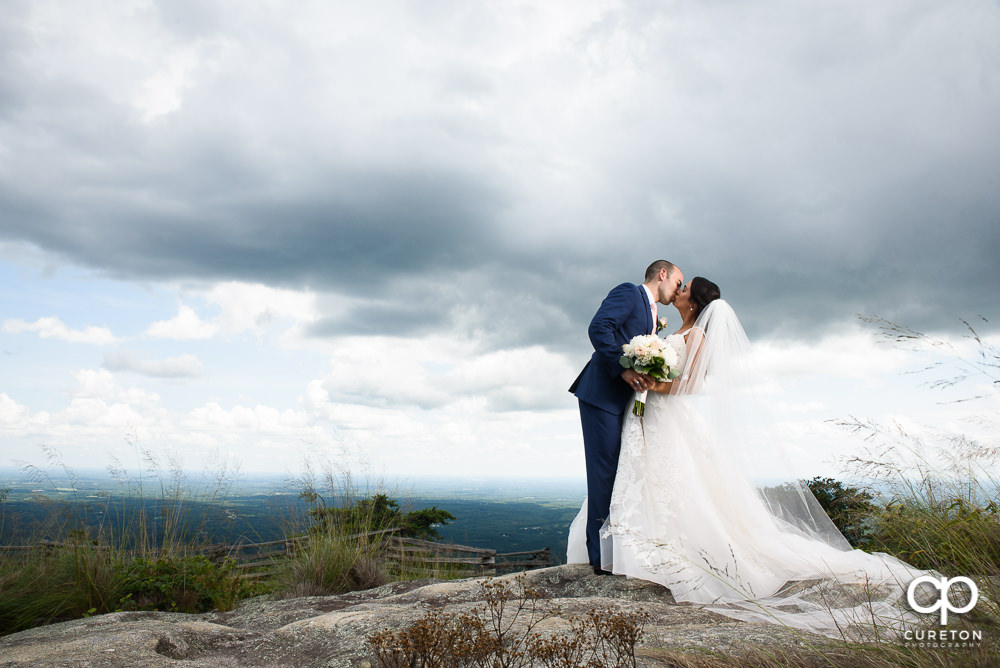 Bride and groom on top of the rock at Glassy Chapel.
