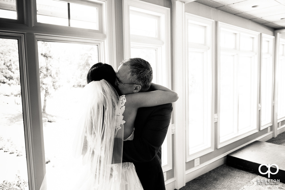 Bride hugging her dad before the ceremony.