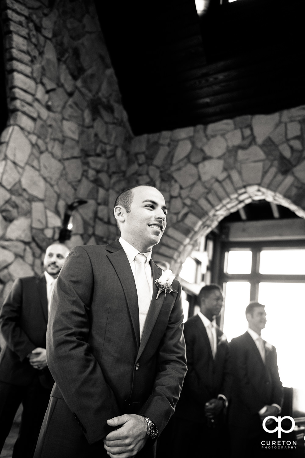 Groom sees his bride for the first time walking down the at the wedding.
