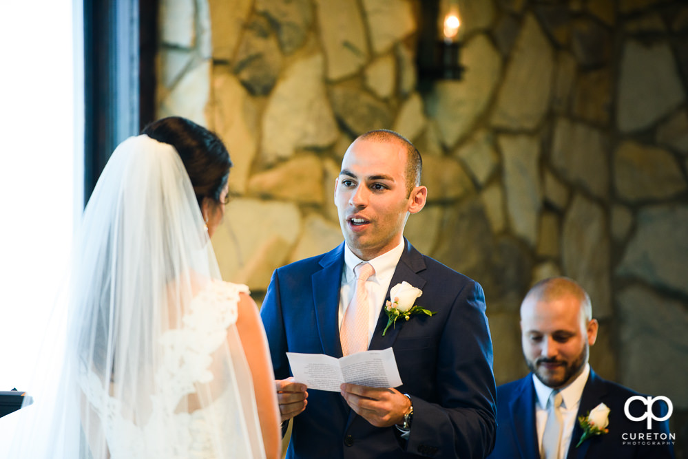 Groom reading his vows.