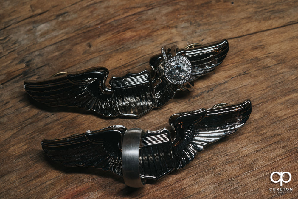 Wedding rings on pilots wings.
