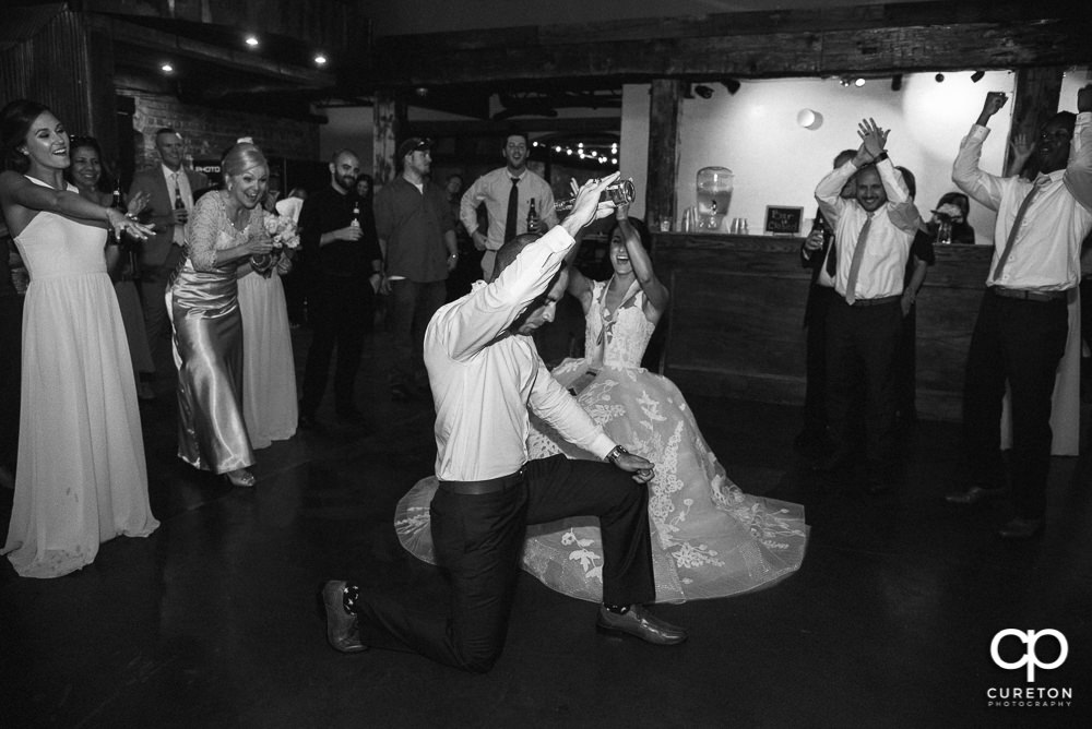 Groom gets iced during the garter removal.