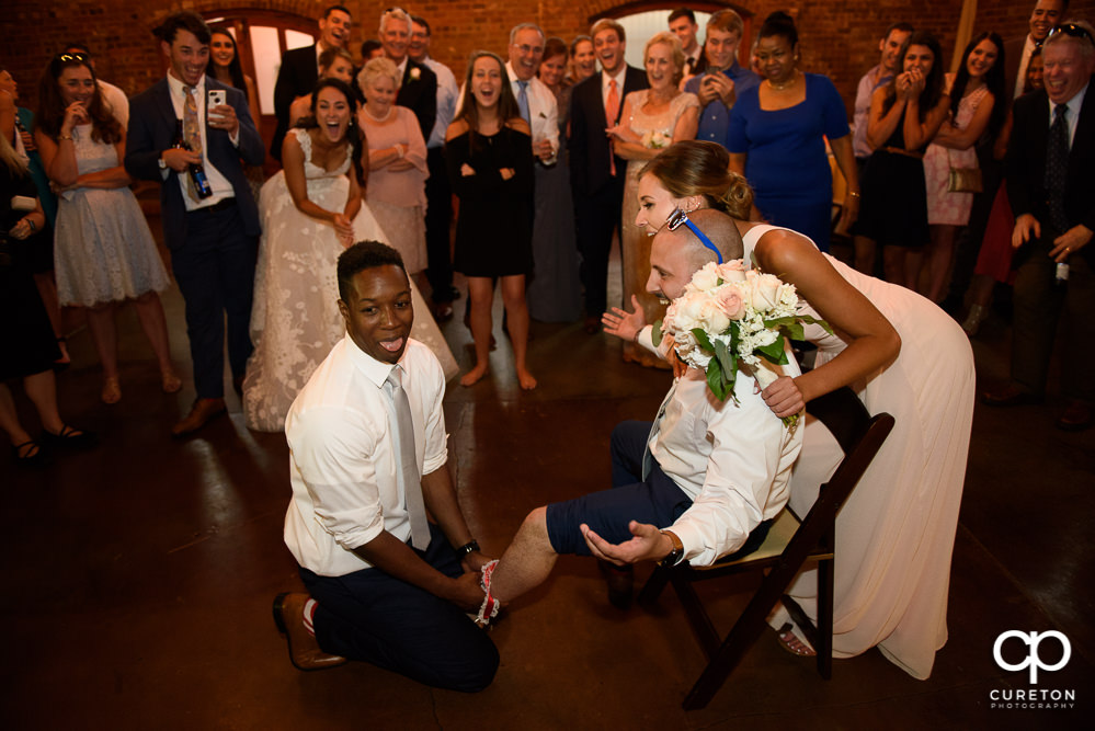 Groomsmen tricked into putting the garter on to another groomsmen instead of the woman who caught the bouquet.
