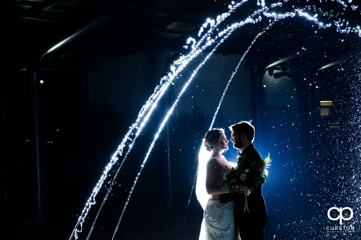 Bride and groom dancing in the fountain at their Greenville Commerce Club wedding.