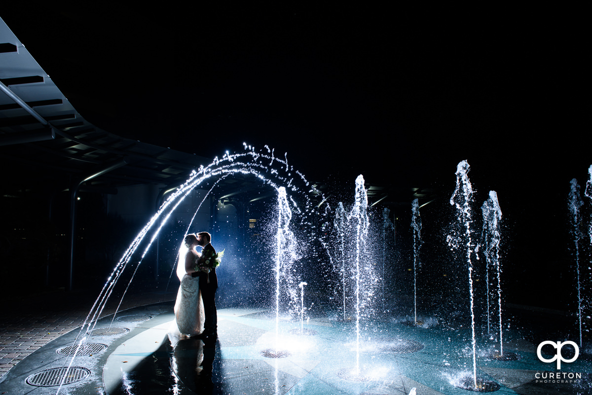 Bride and groom in teh fountain at The Commerce Club.